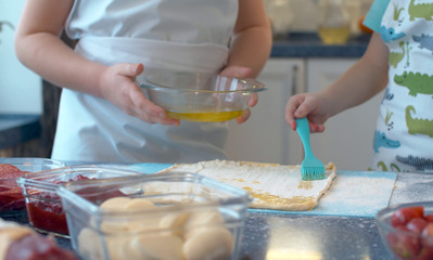 Two young chefs prepare pizza