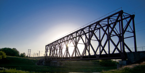 railway bridge at sunset and blue sky