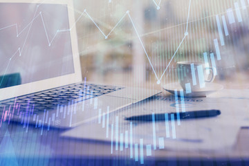 Forex graph hologram on table with computer background. Double exposure. Concept of financial markets.