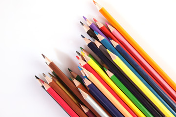Colored pencils lie in a row