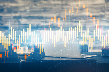 Stock market graph on background with desk and personal computer. Double exposure. Concept of financial analysis.
