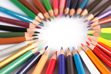 Colored pencils lie in a row