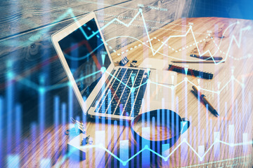 Double exposure of graph and financial info and work space with computer background. Concept of...