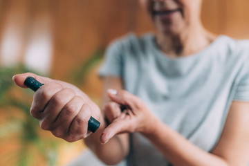 Blood Sugar Finger Prick Testing with Portable Glucometer