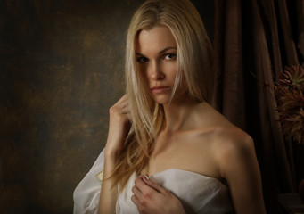 Portrait of a cute blonde girl on a black background