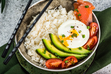 Salmon Sashimi Rice Bowl with Avocado. Healthy food for diet. Healthy bowl. Modern food. Healthy nutrition. Copy space. Salmon, poached egg