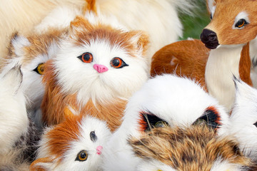 Soft toys kittens sitting in front of the camera