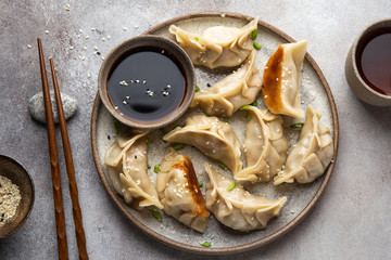 Traditional japaneese gyoza dumplings with meat and mushrooms on ceramic plate - 322720216