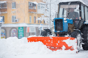 Utility equipment cleans the snow on the streets