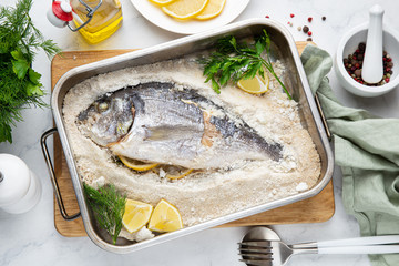 delicious  salt-baked dorada fish with lemon and herbs