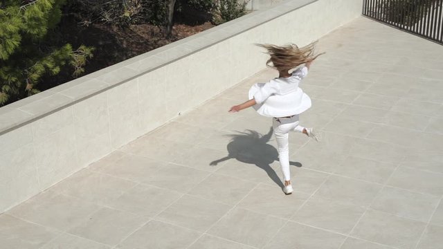 Teen girl dance, spin around, making graceful dancing motions