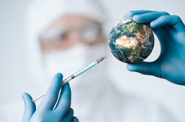 Pandemic concept, close up of scientist injecitng vaccine into the earth - obrazy, fototapety, plakaty