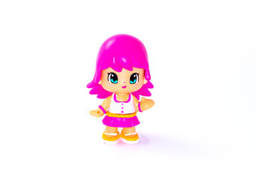 Girl with pink hair toy figurine on white background