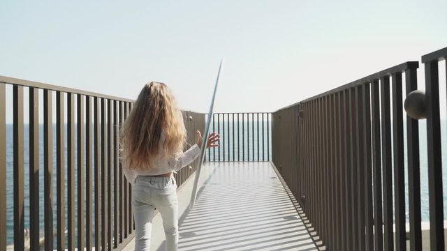 Preteen girl walking with circle plastic ring in hand