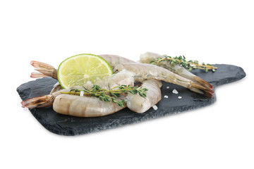Slate plate with raw shrimps, lime and thyme isolated on white
