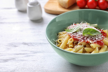 Delicious pasta with tomato sauce served on white wooden table, closeup