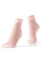 Cropped shot of female feet on tiptoe in pink nylon socks with white reinforced bottoms, toes, rims and zigzag stripe. The photo is made on the white background.  