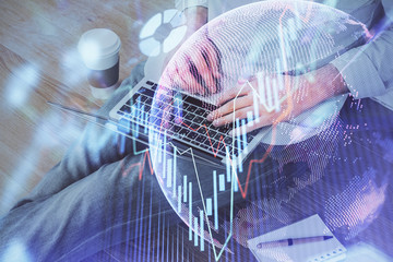 Forex graph with businessman working on computer in office on background. Concept of analysis....