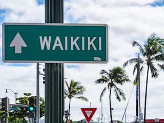 Fototapeta premium Waikiki direction signs in Honolulu, Oahu Island, Hawaii.