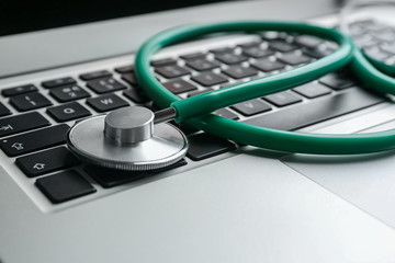 Stethoscope on laptop, closeup. Concept of technical support