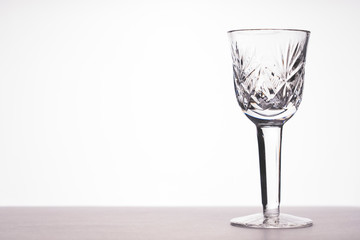 empty glass on the table on a white background, tinted image, selective focus, vignetting