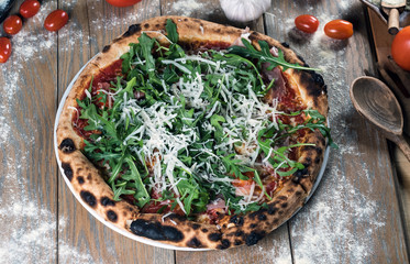 Home made italian style pizza on wooden rustic table