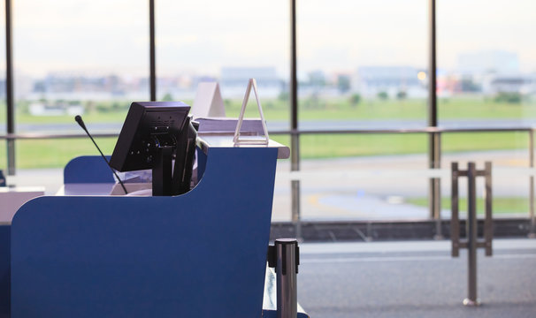 Service Counter for Airline Gate Agents, Stewards, Stewardesses or Ground Attendants in front of a boarding gate in an airport. Business Travel, Workplace, Transportation Industry and Service concept