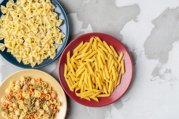 several types of paste in red, yellow and blue ceramic dishes on a background of textured concrete