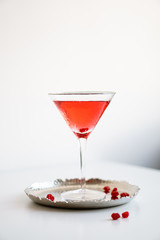 Classic red cocktail in crystal texture glass on white background