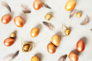 Easter festive pattern with golden eggs and feathers