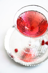 Classic red cocktail in crystal texture glass on white background