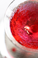 Classic red cocktail in crystal texture glass on white background