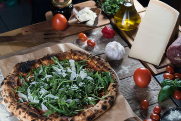 Home made italian style pizza on wooden rustic table