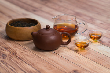 Close-up Yixing clay teapot with tea set on wooden table