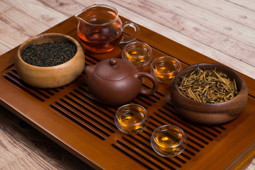 Obraz na płótnie Canvas Close-up of tea set and wooden bowls on a tea table