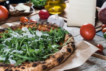 Home made italian style pizza on wooden rustic table