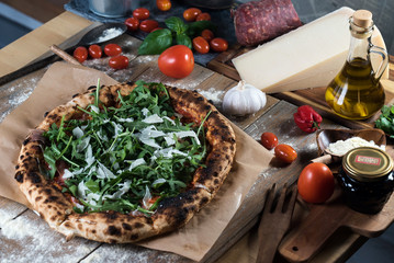 Home made italian style pizza on wooden rustic table