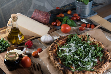 Home made italian style pizza on wooden rustic table
