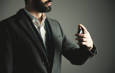 business man hand holding bottle of perfume