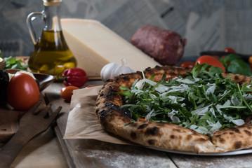 Home made italian style pizza on wooden rustic table