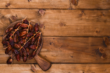 Juicy dates on a wooden table. Dried fruits for a healthy diet. Copy space