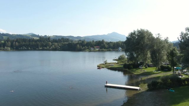 Revealing aerial shot of beautiful lake shore on a warm summer day