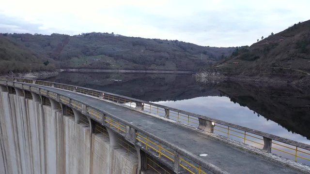 Aerial Parallax Over Reservoir Bridge with Scenic Reflections on Lake