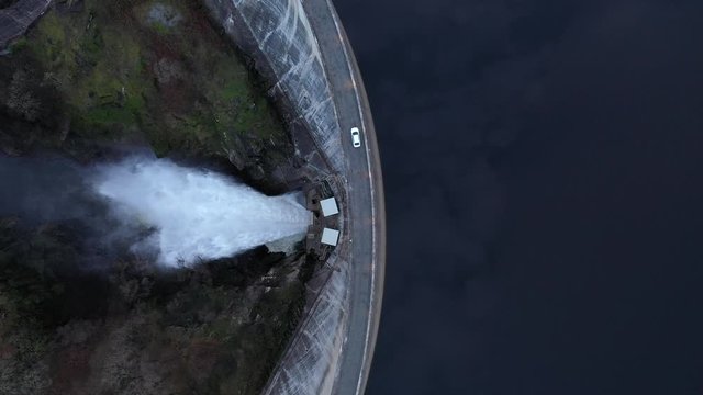 Overhead View Vehicle Driving Over Reservoir
