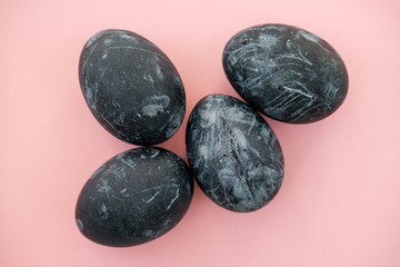 Background with easter eggs. Naturally dyed eggs prepared for Easter on pink background. Happy Easter card. 