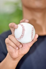 A Young Man Holding Baseball