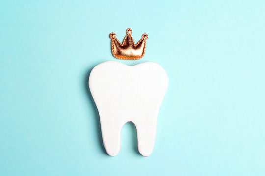 Tooth in the crown on a blue background.
