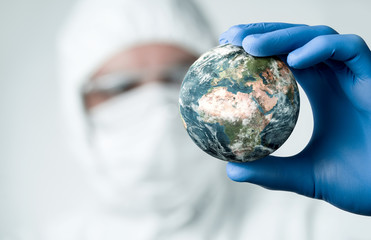 Pandemic concept, close up of scientist holdnig and analyzing planet earth