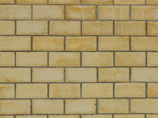 fragment of a wall of light brown blocks with uneven texture