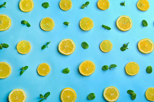 Lemonade layout with juicy lemon slices and mint on light blue background, top view © New Africa